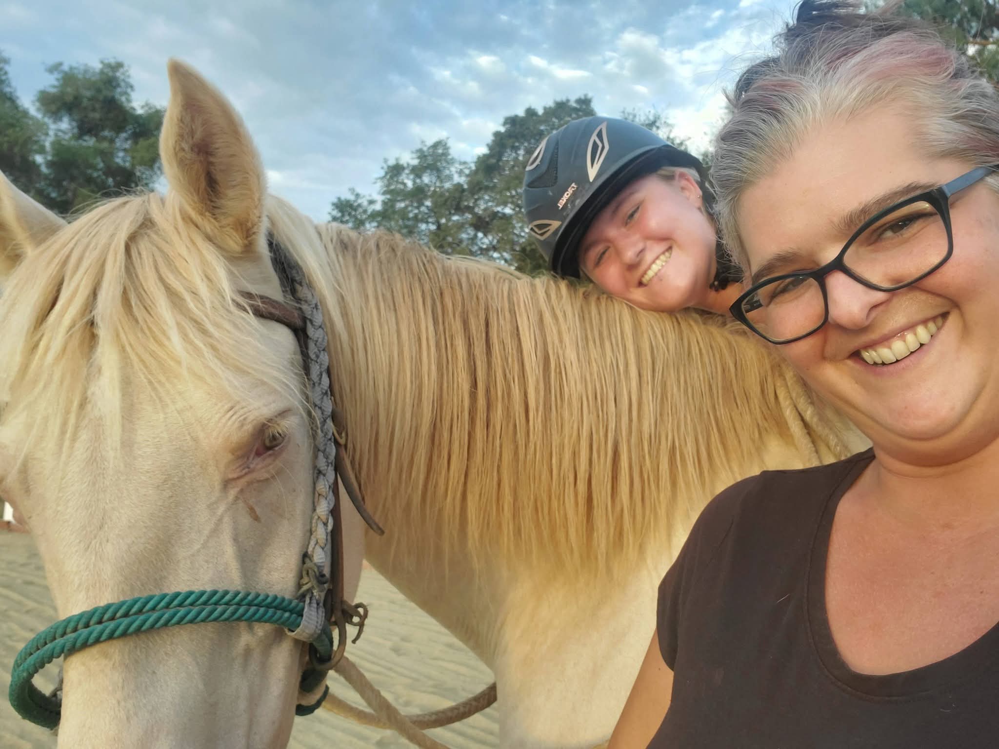 Jalaina, horse, and rider smiling at the camera