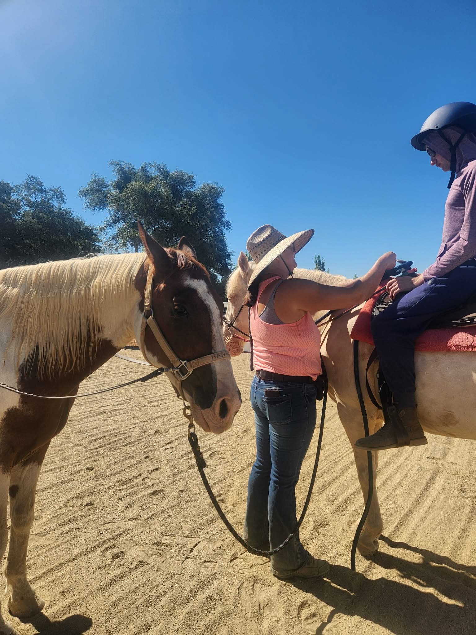 Jalaina adjusting a student's reigns